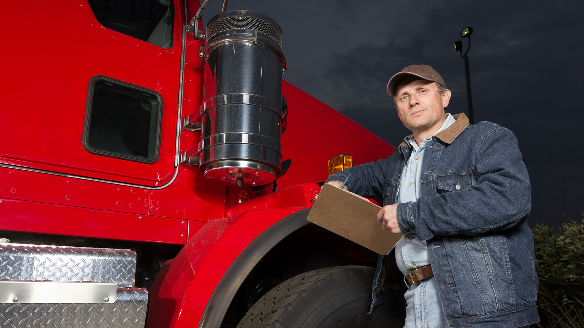Truck driver reading DOT hours of service (HOS) rules